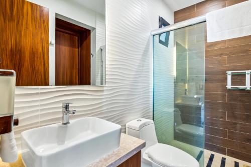 a bathroom with a sink and a toilet and a shower at Portosanto 502 in Puerto Vallarta