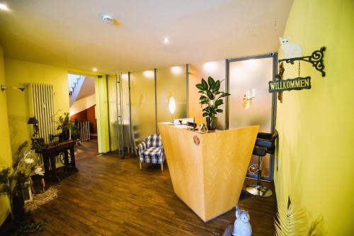 a room with a lobby with a reception desk in it at Hotel Rosenheimer Hof in Traunstein