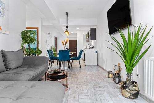 a living room with a couch and a table at Cozy Special City Center - Old Town Apartment with terrace in Bucharest