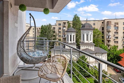 a balcony with a hammock and chairs on a building at Cozy Special City Center - Old Town Apartment with terrace in Bucharest