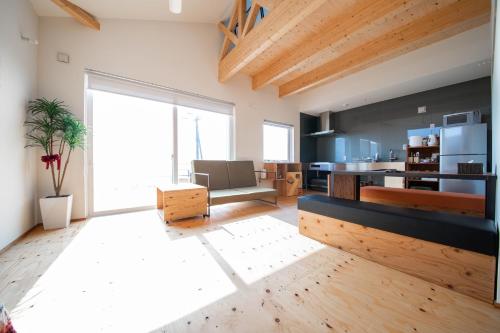 a large living room with a couch and a table at Sunny SIDE HOUSE in Atsuta