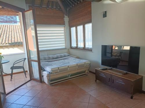 a bedroom with a bed and a flat screen tv at Il cielo in una stanza in Foligno