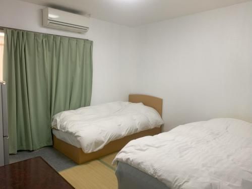 Postel nebo postele na pokoji v ubytování Oyama Guesthouse Kyoto