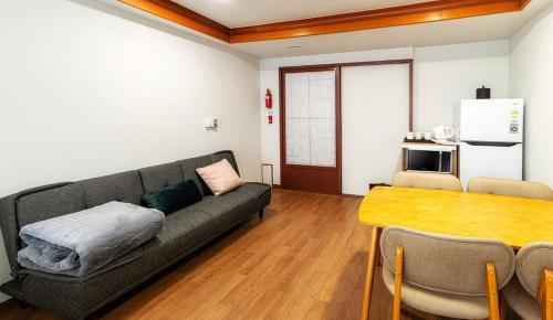 a living room with a couch and a table at Koreana Hotel in Seoul