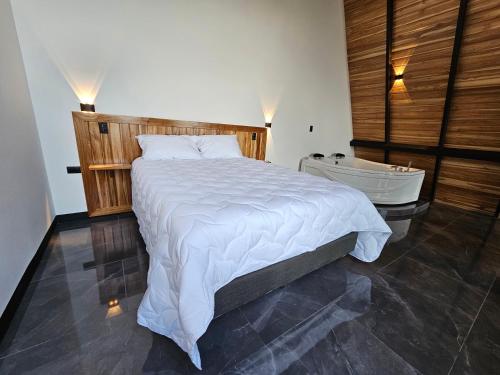a bedroom with a large bed and a bath tub at Wind Houses, Casas de Viento in Monteverde Costa Rica