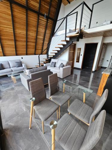 a living room with chairs and a glass table at Wind Houses, Casas de Viento in Monteverde Costa Rica
