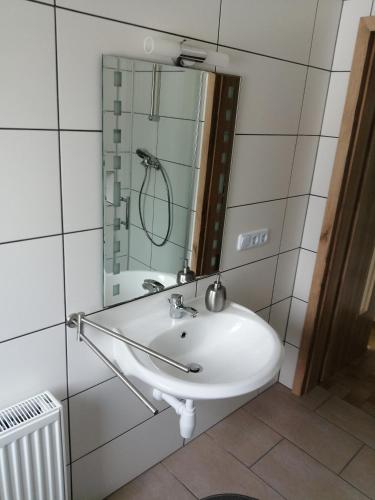 a bathroom with a white sink and a mirror at Wohnung Martha in Bayerisch Eisenstein