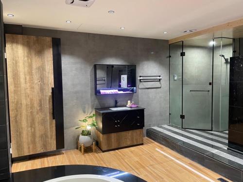 a bathroom with a sink and a shower at Soho Motel in Taoyuan