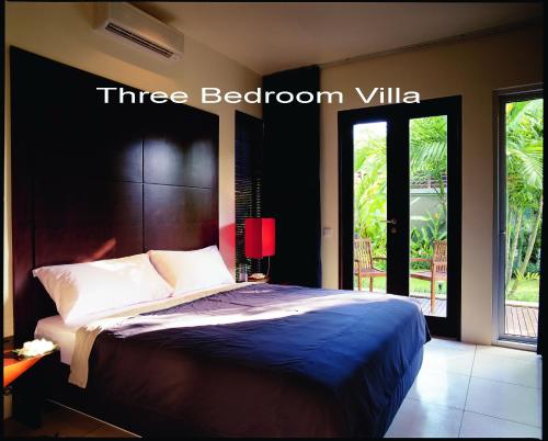 a bedroom with a bed with a three bedroom villa at Villa D'Suite in Seminyak