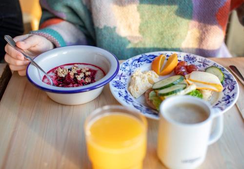 a person sitting at a table with two plates of food at Ski-Inn Hotel Pyhätunturi in Pyhätunturi