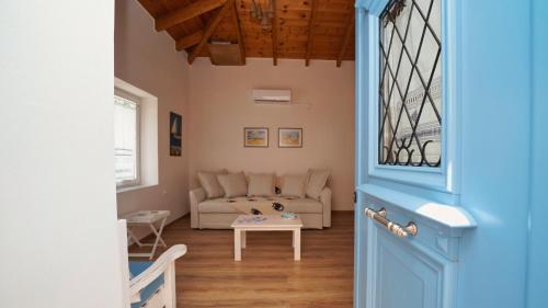 a living room with a couch and a table at Elli in Ermioni