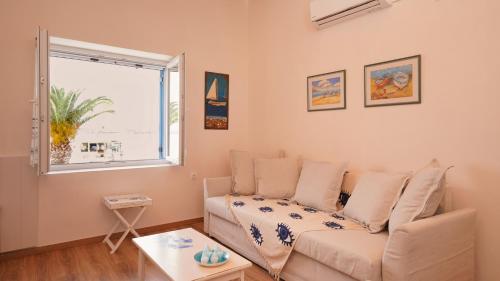a living room with a couch and a window at Elli in Ermioni