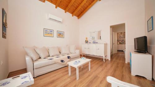 a living room with a couch and a tv at Elli in Ermioni