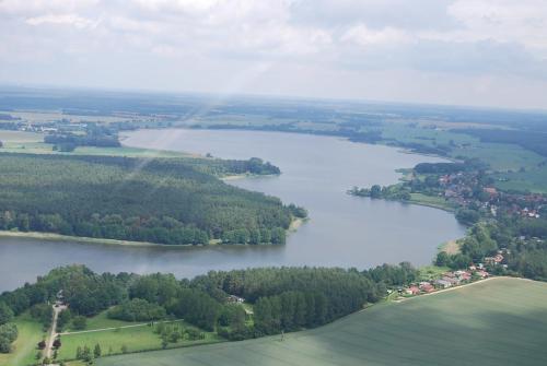 an aerial view of a lake with a rainbow at Alte Büdnerei in Barnin