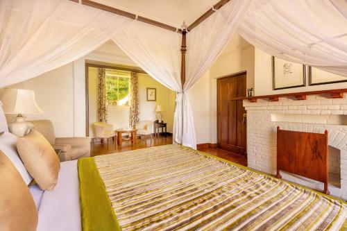 a bedroom with a bed and a fireplace at Mandira Craig Appin by HPL in Hatton