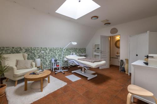 a hospital room with a hospital bed and a table at Penzion Rodos - Café in Prague