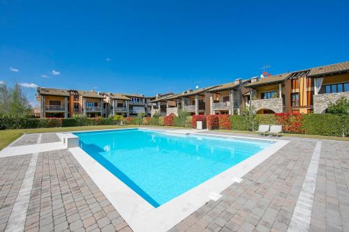 - une piscine au milieu d'une cour dans l'établissement Appartamento Zelda With Shared Pool - Happy Rentals, à Desenzano del Garda