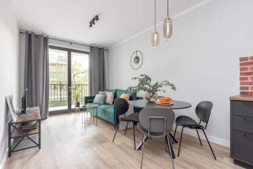 a living room with a table and a couch at Warsaw-Aparts Sokratesa in Warsaw