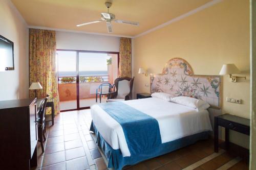 a hotel room with a bed and a balcony at Ibersol Almuñecar Beach & Spa Hotel in Almuñécar