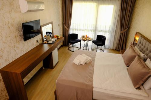 Ένα ή περισσότερα κρεβάτια σε δωμάτιο στο Velmore Hotel & Spa
