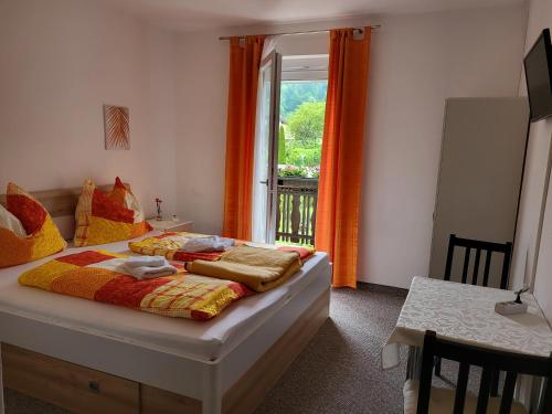 a bedroom with a bed in front of a window at Gästehaus Rosl in Reifnitz