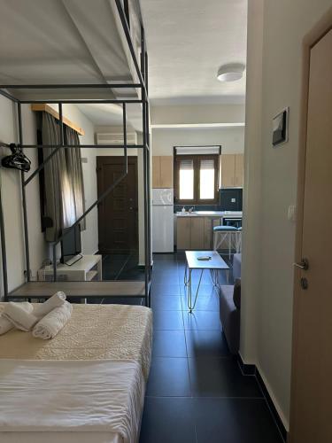 a bedroom with a bed and a living room at Zinozis Beach Apartments in Vourvourou