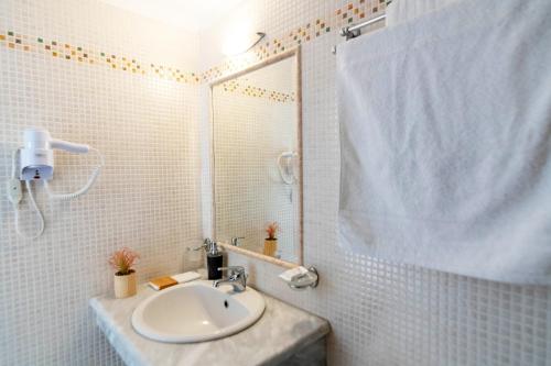 a white bathroom with a sink and a shower at Chora 5 - Central Rooms by TinosHost in Tinos Town