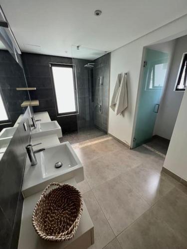 a large bathroom with two sinks and a shower at Luxury Villa - 2 minutes walk from the beach in Grand Baie