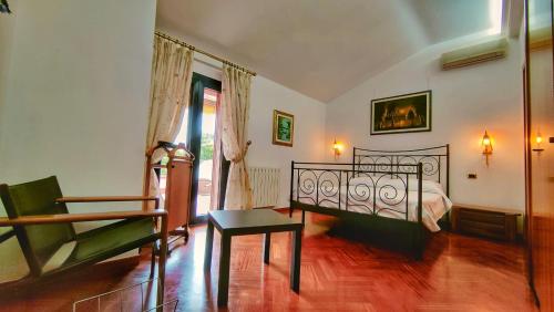 a bedroom with a bed and a chair in it at Villa Vella in Syracuse