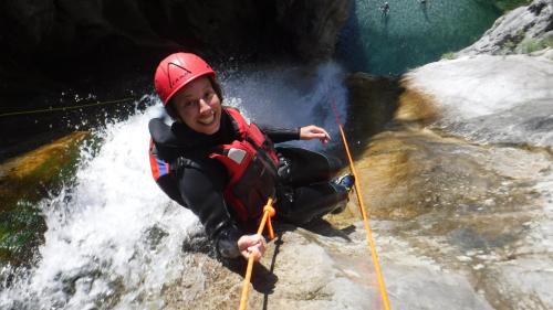 a man is on a raft in a waterfall at Casa Paola in Vesta