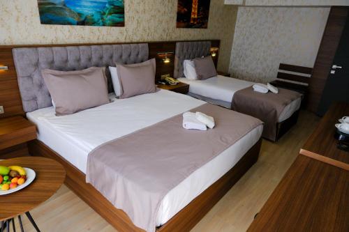 Ένα ή περισσότερα κρεβάτια σε δωμάτιο στο Velmore Hotel & Spa