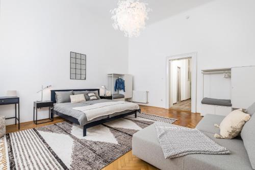 a bedroom with a bed and a couch at City Center Apartment with Balcony in Budapest