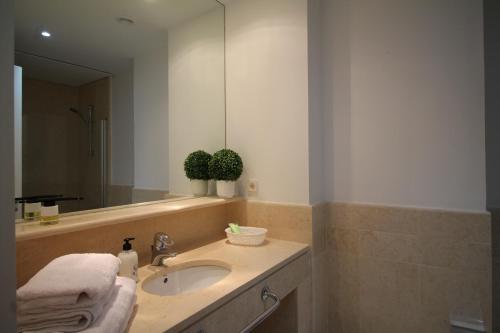 uma casa de banho com um lavatório e um espelho em New view Sotogrande Marina - Jungla del Loro em Sotogrande