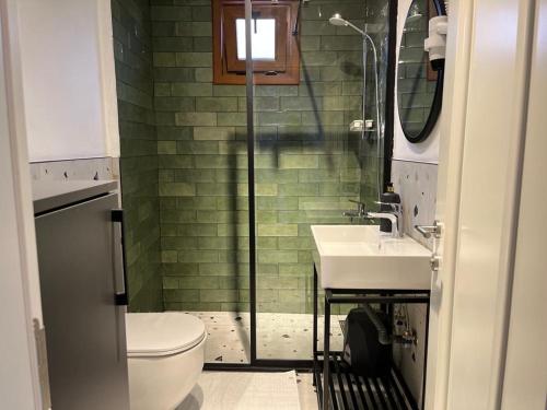 a bathroom with a toilet and a sink and a shower at The pillo loft in Istanbul