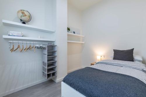 a bedroom with a bed and a clock on the wall at Travel Habitat Ruzafa in Valencia