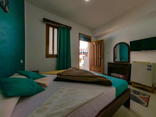 a bedroom with two beds and a mirror at Octopus Hotel in Dahab