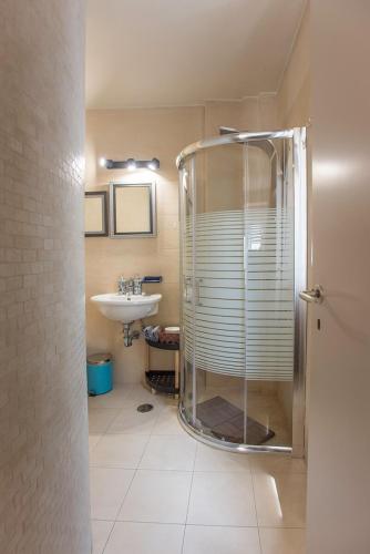 a bathroom with a shower and a sink at The Fifty Condo in Heraklio Town