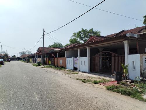an empty street with a row of houses at Syah Homestay in Dungun