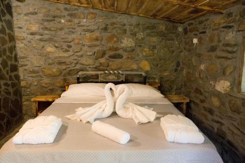 a bed with two swans made out of towels at Captain Ikaros in Agios Kirykos