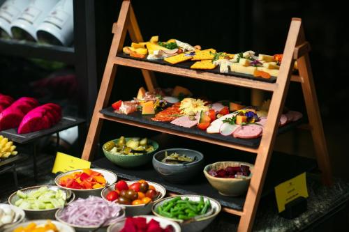 a display of different types of food on a shelf at La Sinfonía Majesty Hotel and Spa in Hanoi