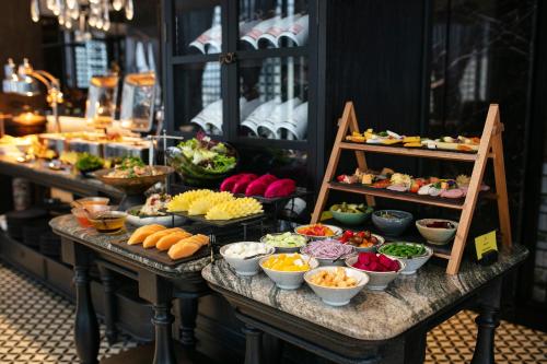 a buffet with different types of food on a table at La Sinfonía Majesty Hotel and Spa in Hanoi