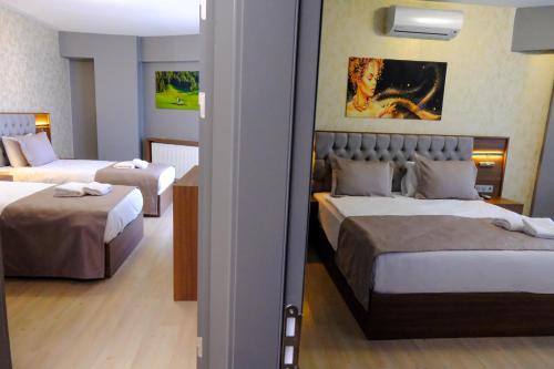 Ένα ή περισσότερα κρεβάτια σε δωμάτιο στο Velmore Hotel & Spa