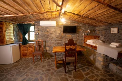 a room with a table and a bed and a bedroom at Captain Ikaros in Agios Kirykos