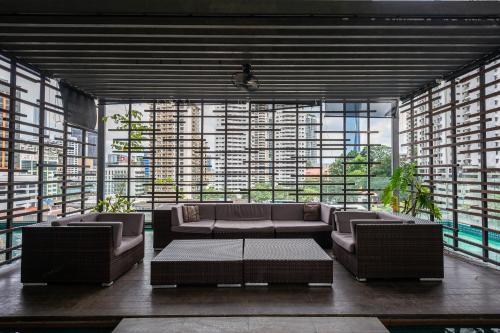 a living room with couches and a large window at MyRehat Suites Bukit Ceylon in Kuala Lumpur