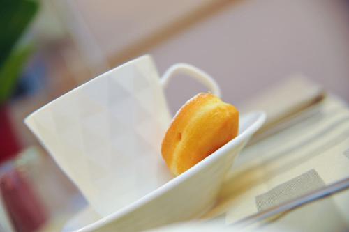 a piece of food in a white bowl on a table at Hotel Dori in Peschiera del Garda