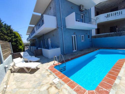 a house with a swimming pool next to a building at Ble Island in Hersonissos