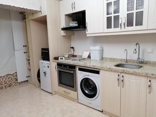 eine Küche mit einer Spüle und einer Waschmaschine in der Unterkunft İstanbul Havalimanı 30 Dakika in Sultançiftliği Köyü