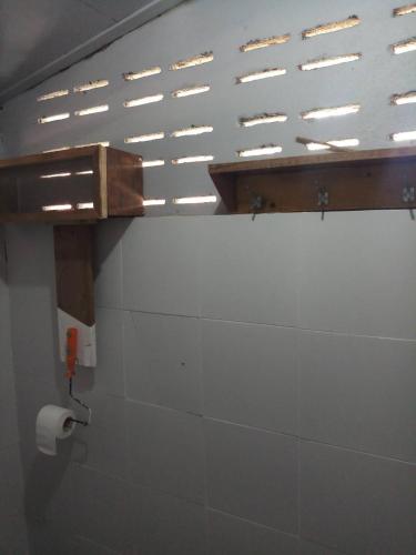 a bathroom with a toilet paper dispenser on a wall at บ้านน่านโฮมสเตย์ in Nan