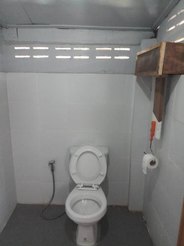 a small bathroom with a toilet in a stall at บ้านน่านโฮมสเตย์ in Nan