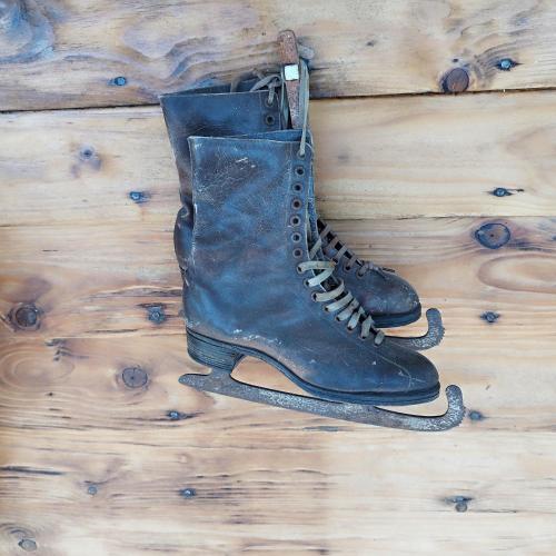 a pair of boots hanging on a wooden floor at le chalet des remparts in Aywaille